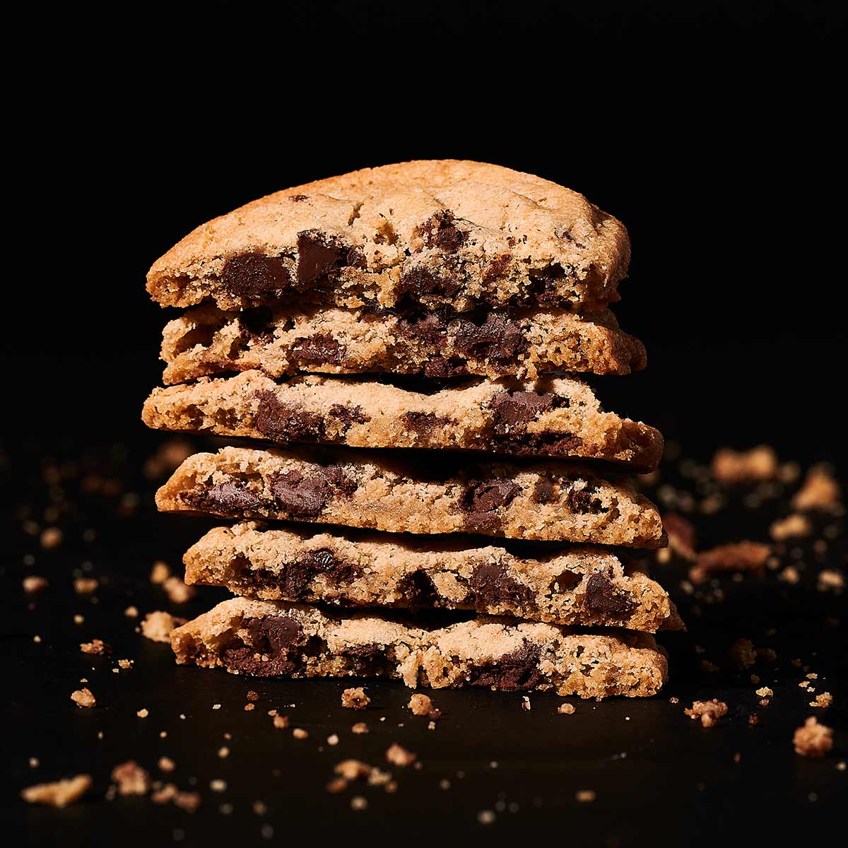 A stack of six chocolate-chip cookies cut in half.